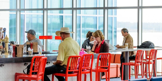 Houston, TX, USA - September 14, 2014: IAH, Houston Intercontinental Airport, Houston, TX, USA - people seated at restaurant bar in an airport