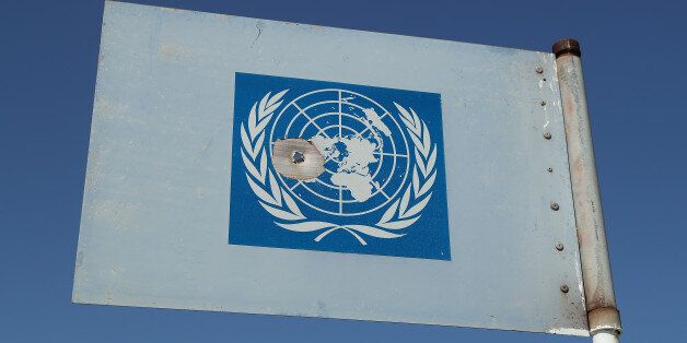 DUCZE, CYPRUS - MARCH 06: A United Nations metal flag with a bullet hole in it stands on a U.N. peacekeepers' viewing platform near a militarized zone of the Turkish Republic of North Cyprus (TRNC) next to the British Soverign Base Area on March 6, 2017 near Duzce, Cyprus. Cyprus has been divided into a Greek south and Turkish north ever since the brief but devastating war of 1974. Since then United Nations peacekeepers have maintained a buffer zone that runs through the capital city of Nicosia and across the entire island to keep the factions apart. In the south the Greek-dominated Republic of Cyprus is internationally-recognized and a member of the European Union, while in the north the self-proclaimed Turkish Republic of North Cyprus (TRNC) is recognized only by Turkey, which also has tens of thousands of troops stationed there. Negotiations over possible reunification have made strident progress over the last few years, though they have stalled in recent months. Britain maintains two military bases on the southern part of the island that it controls as soverign territory. (Photo by Sean Gallup/Getty Images)