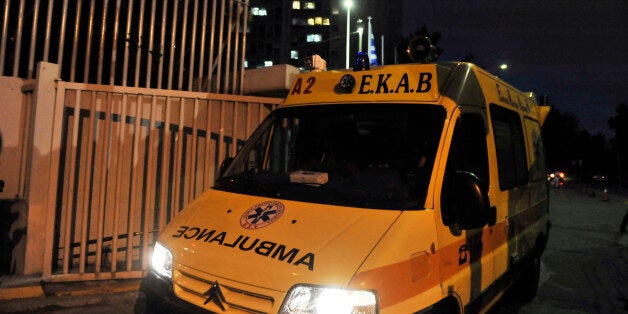 GREECE, ATHENS - JUNE 24: A ambulance sits at the entrance to the police headquarters and Ministry of Civil Protection after parcel bomb explosion on June 24, 2010 in Athens, Greece. A political aide was killed after the bomb - which was diguised as a gift - went off inside the government offices. No one has claimed repsonsibilty for the bombing. (Photo by Milos Bicanski/Getty Images)