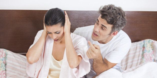 unhappy couple in a bed, having argument conflict problem, man scream on woman