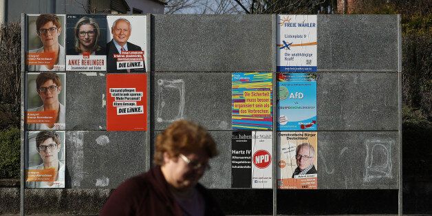 SCHWALBACH, GERMANY - MARCH 15: A woman walks past election campaign posters on March 15, 2017 in Schwalbach, Germany. Schwalbach is in the industrial heartland of Saarland, the small German state that borders France and has a long history of coal and steel production. Saarland faces state elections on March 26 and so far the Christian Democrats (CDU) and Social Democrats (SPD) are leading in polls. The right-wing populist Alternative for Germany (AfD) has slipped in polls in the last two months, though it is still likely to get seats in the state parliament. (Photo by Sean Gallup/Getty Images)