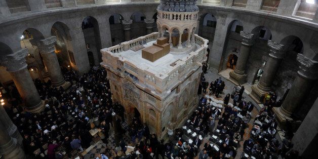 Christian clergymen and other guests attend a ceremony marking the end of restoration work on the site of Jesus's tomb, in the Church of the Holy Sepulchre, in Jerusalem's Old City March 22, 2017. REUTERS/Menahem Kahana/Pool