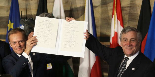 European Council President Donald Tusk (L) and European Parliament President Antonio Tajani hold up a document signed by EU leaders during their meeting on the 60th anniversary of the Treaty of Rome, in Rome, Italy March 25, 2017. REUTERS/Remo Casilli