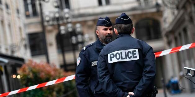 French police officers stand guard at a cordoned off area in front of the financial crimes court building (pole financier du tribunal de grande instance) following a bomb alert in central Paris on March 20, 2017.The building was evacuated on Monday morning following an anonymous call of the presence of a bomb, according to a source close to the investigation. / AFP PHOTO / Lionel BONAVENTURE (Photo credit should read LIONEL BONAVENTURE/AFP/Getty Images)