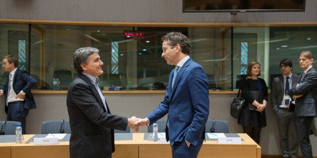 Euclid Tsakalotos, Greece's finance minister, left, shakes hands with Jeroen Dijsselbloem, Dutch finance minister and head of the group of euro-area finance ministers, during a Eurogroup meeting of finance ministers in Brussels, Belgium, on Monday, Feb. 20, 2017. As Greek efforts to conclude a year-old review of its rescue program stall, the governments ability to regain access to the public debt market grows slimmer, increasing the possibility Athens will have to seek another unpopular strings-
