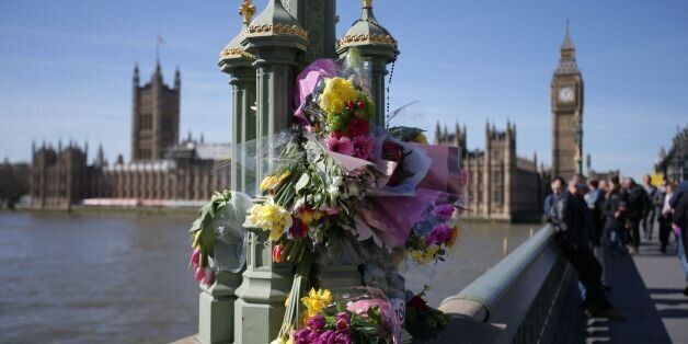 Floral tributes to the victims of the March 22 terror attack are seen on Westminster Bridge near the Houses of Parliament in central London on March 26, 2017.The British government said on March 26 that its security services must have access to encrypted messaging applications such as WhatsApp, revealing it was used by the killer behind the parliament attack. / AFP PHOTO / Daniel LEAL-OLIVAS (Photo credit should read DANIEL LEAL-OLIVAS/AFP/Getty Images)