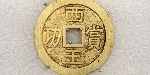 MEISHAN, March 20, 2017 -- Photo taken on March 17, 2017 shows a gold coin unearthed during an archaeological excavation at Pengshan District in Meishan City, southwest China's Sichuan Province. More than 10,000 gold and silver items that sank to the bottom of a river in Sichuan Province over 300 years ago have been recovered, archeologists said Monday. The items included a large amount of gold, silver and bronze coins and jewelry as well as iron weapons such as swords, knifes and spears. (Xinhua/Chen Xie via Getty Images)