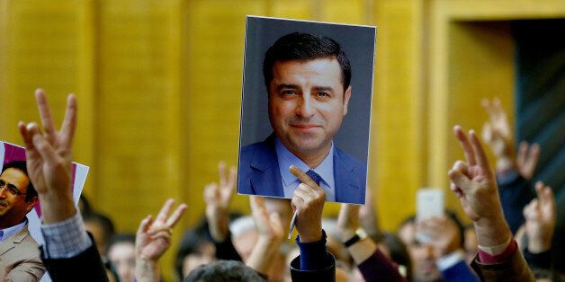 A supporter holds a portrait of Selahattin Demirtas, detained leader of Turkey's pro-Kurdish opposition Peoples' Democratic Party (HDP) at a meeting at the Turkish parliament in Ankara, Turkey, November 8, 2016, in the absence of Demirtas and other HDP lawmakers who were jailed after refusing to give testimony in a probe linked to