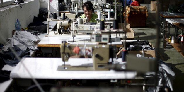 An employee sews while working in a factory in the city of Blagoevgrad, Bulgaria July 2, 2015. Greece is the third-largest investor in Bulgaria and is also Bulgaria's fourth-largest export destination. Picture taken on July 2, 2015. To match EUROZONE-GREECE/BULGARIA REUTERS/Stoyan Nenov