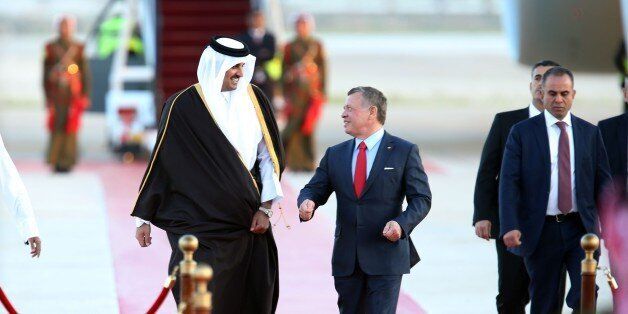 AMMAN, JORDAN - MARCH 28: Emir of Qatar, Tamim bin Hamad Al Thani (L) is welcomed by Jordan's King Abdullah II (R) with an official ceremony at Queen Alia International Airport, as part of the 28th Arab League Summit in Amman, Jordan on March 28, 2017. (Photo by Salah Malkawi/Anadolu Agency/Getty Images)