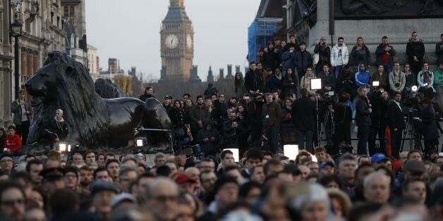 People gather for a vigil in Trafalgar Square in central London on March 23, 2017 in solidarity with the victims of the March 22 terror attack at the British parliament and on Westminster Bridge. Britain's parliament reopened on Thursday with a minute's silence in a gesture of defiance a day after an attacker sowed terror in the heart of Westminster, killing three people before being shot dead. Sombre-looking lawmakers in a packed House of Commons chamber bowed their heads and police officers also marked the silence standing outside the headquarters of London's Metropolitan Police nearby. / AFP PHOTO / Adrian DENNIS (Photo credit should read ADRIAN DENNIS/AFP/Getty Images)