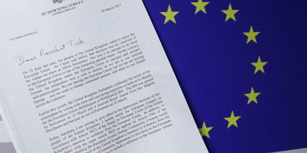 A copy of British Prime Minister Theresa May's Brexit letter in notice of the UK's intention to leave the bloc under Article 50 of the EU's Lisbon Treaty, is placed next to a European Flag in this March 29, 2017 photo illustration. REUTERS/Yves Herman /Photo Illustration