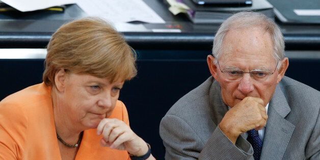 German Chancellor Angela Merkel speaks with Finance Minister Wolfgang Schaeuble during a parliamentary debate on the Greek debt crisis at the German lower house of parliament Bundestag in Berlin, Germany, July 1, 2015. REUTERS/Fabrizio Bensch