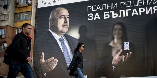 Bulgarians walk past an election poster bearing a portrait of the head of the centre-right GERB party and former prime minister Boyko Borisov on March 24, 2017 in Sofia, ahead of the parliamentary election, the thirds in four years in the country.Bulgaria's upcoming parliamentary election, held on March 26, 2017, raises the prospect of the EU's poorest country tilting more towards Russia if the Socialists emerge as winners and can form a government. In November, Bulgarians elected Rumen Radev, an air force commander backed by the Socialists (BSP) and seen as sympathetic to Russia, as president. / AFP PHOTO / NIKOLAY DOYCHINOV (Photo credit should read NIKOLAY DOYCHINOV/AFP/Getty Images)