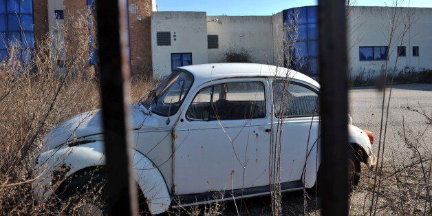TO GO WITH AFP STORY BY VASSILIS KYRIAKOULIS Photo taken on January 15, 2015 shows a Volkswagen Beetle parked near a closed factory in Komotini, northern Greece. In Komotini, a city with a strong Muslim population, previously buzzing factories lie empty, the only movement that of looter gangs who strip the buildings bare of metals and machinery at night. 'Fifteen years ago, 17,000 people would come through the gates here to work,' says Pantelis Magalios, head of the Komotini trade union centre. 'Today there are barely 800 employees. And out of 100 businesses and factories, only ten are left,' he says. AFP PHOTO / SAKIS MITROLIDIS (Photo credit should read SAKIS MITROLIDIS/AFP/Getty Images)