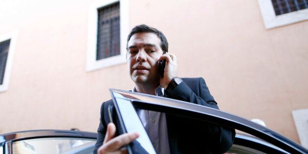Greek radical left unified party President Alexis Tsipras talks on his mobile phone as he arrives for a news conference for foreign press during his visit in Rome February 7, 2014. REUTERS/Alessandro Bianchi (ITALY - Tags: POLITICS)