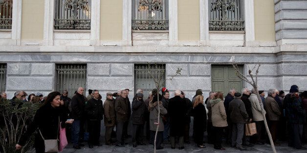 Pensioners queue outside of a National bank branch in central Athens Greece, early in the morning on Thursday December 22, 2016. Pensioners wait to receive their pensions and "EKAS" the monthly benefit allocated to some 260,000 low-income pensioners that will be cut by 50 percent in 2017, a development that comes in the wake of a one-off "holiday benefit" given this month to 1.6 million pensioners. (Photo by Panayiotis Tzamaros/NurPhoto via Getty Images)