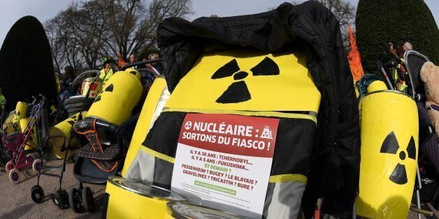 French and German anti-nuclear activists push strollers and banners reading 'nuclear : leave the fiasco !' as they take part in the commemoration of the nuclear disaster in Fukushima and protest against the nuclear powerplant of Fessenheim, France's oldest nuclear reactor on March 11, 2017 in Strasbourg, eastern France.Fessenheim, located on a seismic fault line, has worried French, German and Swiss environmentalists for years and its fate has been the subject of dispute with Berlin. / AFP PHOTO / FREDERICK FLORIN (Photo credit should read FREDERICK FLORIN/AFP/Getty Images)
