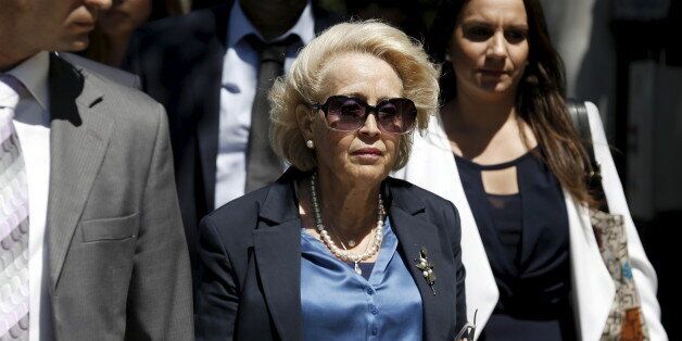 Greece's newly appointed caretaker Prime Minister Vassiliki Thanou (C) leaves her office at the Maximos Mansion to attend her government's swearing-in ceremony at the Presidential Palace in Athens, August 28, 2015. Thanou, the country's first female prime minister, was named the head of a caretaker government to lead the country to elections expected next month, the president's office said on Thursday. REUTERS/Alkis Konstantinidis