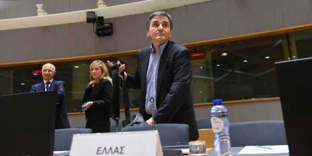 Greek Finance Minister Euclid Tsakalotos (C) arrives to attend an Eurogroup meeting at the EU headquarters in Brussels on February 20, 2017. / AFP / JOHN THYS (Photo credit should read JOHN THYS/AFP/Getty Images)