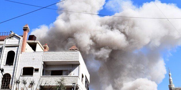 DAMASCUS, SYRIA - FEBRUARY 25: Smoke rises after Assad Regime's airstrike over civilians in residential...
