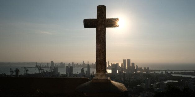 CARTAGENA of INDIAS, COLOMBIA - JANUARY 26, 2017: A dramatic cityscape at sunset seen from behind a cross standing erect on the highest city ground where La Popa Monastery is situated on January 26, 2017 in Cartagena, Colombia. The Convent of Santa Cruz de la Popa offers a sweeping view on Cartagena. (Photo by Kaveh Kazemi/Getty Images)