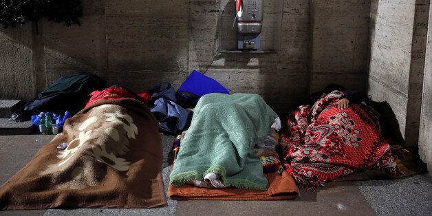 Homeless people sleep in passageway near St. Peter's square in Rome, Italy, January 11, 2017. REUTERS/Stefano Rellandini