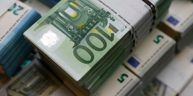 Wads of euro banknotes are stacked in a pile at the Money Service Austria company's headquarters in Vienna, Austria, March 3, 2016. REUTERS/Leonhard Foeger