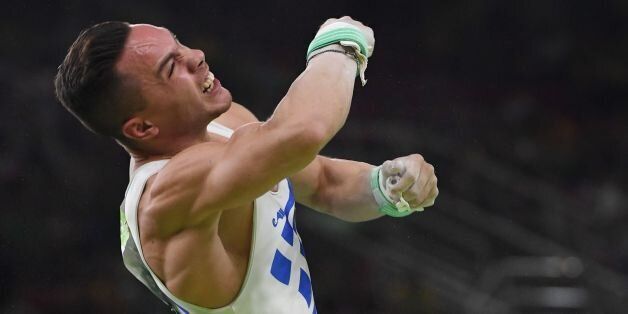 Greece's Eleftherios Petrounias competes in the men's rings event final of the Artistic Gymnastics at the Olympic Arena during the Rio 2016 Olympic Games in Rio de Janeiro on August 15, 2016. / AFP / Toshifumi KITAMURA (Photo credit should read TOSHIFUMI KITAMURA/AFP/Getty Images)