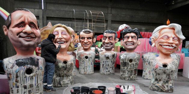 A worker puts the final touches to giant figures of French politicians (L-R) French President Francois Hollande, Marine Le Pen, Alain Juppe, Emmanuel Macron, Nicolas Sarkozy, Jean-Luc Melenchon and Michele Alliot-Marie during preparations for the carnival parade in Nice, France, January 26, 2017. REUTERS/Eric Gaillard