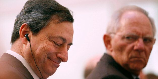 Mario Draghi, president of the European Central Bank (ECB), left, listens as Wolfgang Schaeuble, Germany's finance minister, gestures during the 'Ludwig Erhard Lecture' event in Berlin, Germany, on Thursday, Dec. 15, 2011. Draghi said there is no 'external savior' for countries that don't implement structural reforms to restore confidence to debt markets. Photographer: Michele Tantussi/Bloomberg via Getty Images