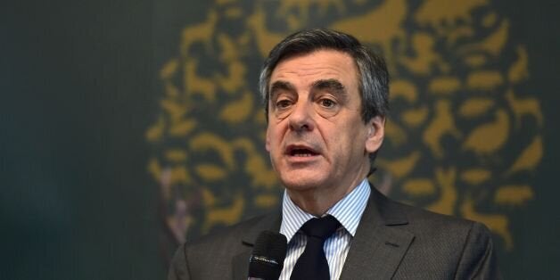 French presidential election candidate for the right-wing Les Republicains (LR) party Francois Fillon (C) delivers a speech during a meeting of the General Assembly of the French National Federation of Hunters on March 14, 2017 in Paris. France's rightwing presidential candidate Francois Fillon has been charged with several offences over a fake jobs scandal, including for misuse of public funds, his lawyer told AFP on March 14, 2017. / AFP PHOTO / CHRISTOPHE ARCHAMBAULT (Photo credit sho