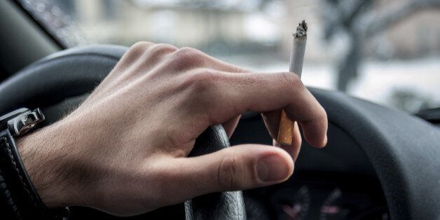 Teenage smoking while driving a car