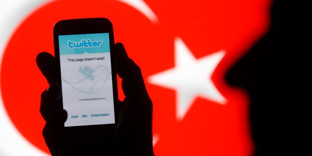 A holds holds a Samsung Galaxy S4 displaying a Twitter error message in front of Turkish national flag in this illustration taken in Zenica, March 21, 2014. Turkey's courts have blocked access to Twitter a little over a week before elections as Prime Minister Tayyip Erdogan battles a corruption scandal that has seen social media awash with alleged evidence of government wrongdoing. The ban came hours after a defiant Erdogan, on the campaign trail ahead of key March 30 local elections, vowed to