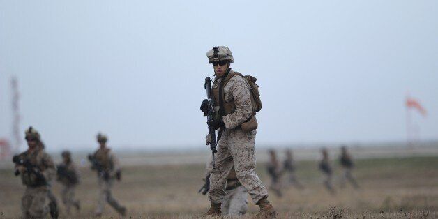 US marines perform a demonstration during the visit of US Secretary of Defense and Spanish Defence Minister to the US marines base in Moron de la Frontera October 6, 2015. Carter's is on a five day European trip aimed at thanking allies from the US-led coalition that is carrying out daily drone and plane strikes against IS in Iraq and Syria. Spain has agreed to the establishment of a permanent force of 2,200 US marines to intervene in Africa, at Moron de la Frontera site. AFP PHOTO / CRISTINA QUICLER (Photo credit should read CRISTINA QUICLER/AFP/Getty Images)