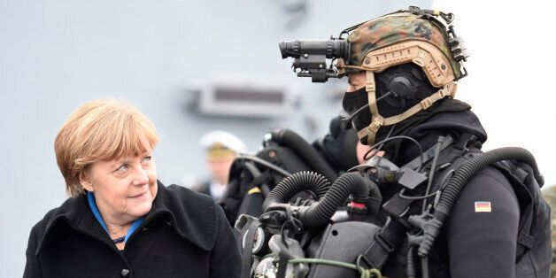 German Chancellor Angela Merkel looks at a combat diver during her visit to Naval Base Command in Kiel, Germany, January 19, 2016. REUTERS/Fabian Bimmer TPX IMAGES OF THE DAY