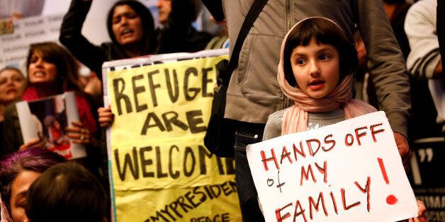 Rosalie Gurna, 9, holds a sign in support of Muslim family members as people protest against U.S. President Donald Trump's travel ban on Muslim majority countries, at the International terminal at Los Angeles International Airport (LAX) in Los Angeles, California, U.S., January 28, 2017. REUTERS/Patrick T. Fallon TPX IMAGES OF THE DAY