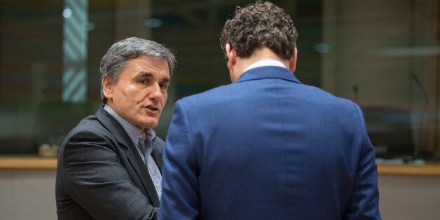 Euclid Tsakalotos, Greece's finance minister, left, speaks with Jeroen Dijsselbloem, Dutch finance minister and head of the group of euro-area finance ministers, during a Eurogroup meeting of finance ministers in Brussels, Belgium, on Monday, Feb. 20, 2017. As Greek efforts to conclude a year-old review of its rescue program stall, the governments ability to regain access to the public debt market grows slimmer, increasing the possibility Athens will have to seek another unpopular strings-attached bailout program. Photographer: Jasper Juinen/Bloomberg via Getty Images