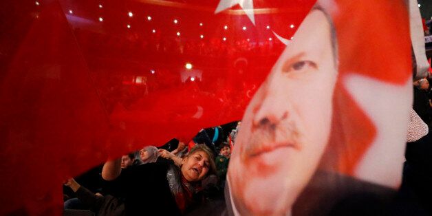 People wave with flags showing Turkish President Recep Tayyip Erdogan before Turkish Prime Minister Binali Yildirim is expected to address a crowd of around 10,000 in Oberhausen, Germany, February 18, 2017, to promote Turkey's constitution referendum on April 16, 2017. REUTERS/Wolfgang Rattay TPX IMAGES OF THE DAY