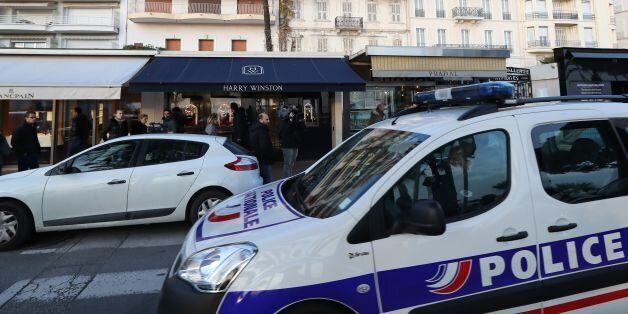 A police car drives past the Harry Winston jewelry shop on the Croisette promenade in Cannes, southern France, on January 18, 2017, a few hours after a robbery took place at the shop. / AFP / Valery HACHE (Photo credit should read VALERY HACHE/AFP/Getty Images)