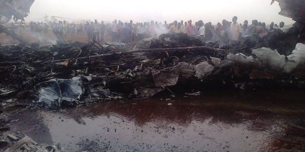 A picture taken on March 20, 2017 in South Sudan's northwestern city of Wau shows people gathering near a plane wreckage after a jet crash-landed, leaving at least 37 people injured, government and airport officials said.At least 37 people were injured when a passenger jet crash-landed in South Sudan's northwestern city of Wau on Monday, government and airport officials said. There were 40 passengers and five crew members on board the South Supreme Airlines plane that had taken off from the capital Juba, said the airline's manager Gabriel Ngang. / AFP PHOTO / STRINGER (Photo credit should read STRINGER/AFP/Getty Images)