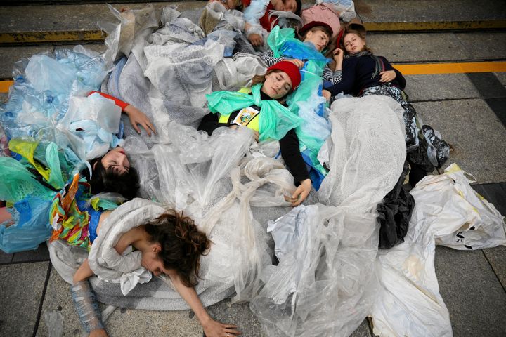 Young activists stage a performance during an environmental demonstration, part of the Global Climate Strike, in Warsaw, Poland September 20, 2019.