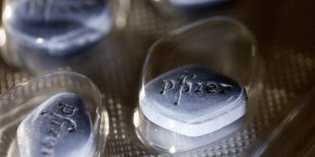 The Pfizer logo sits on Viagra tablets, produced by Pfizer Inc., inside a blister pack sitting on a pharmacy counter in this arranged photograph in London, U.K., on Monday, Dec. 14, 2015. European pharmaceuticals stocks in 2015 have outperformed the Stoxx 600 Index by 1.2 percentage points in U.S. dollar terms. Photographer: Simon Dawson/Bloomberg via Getty Images