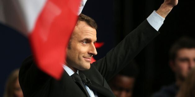 French presidential election candidate for the En Marche! movement Emmanuel Macron waves to supporters as he delivers a speech during a campaign rally in Reims, northeastern France, on March 17, 2017. / AFP PHOTO / FRANCOIS NASCIMBENI (Photo credit should read FRANCOIS NASCIMBENI/AFP/Getty Images)