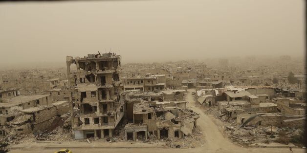 A picture taken during a sandstorm shows destruction in the once rebel-held Karm al-Jabal neighbourhood in the northern city of Aleppo on March 10, 2017. / AFP PHOTO / JOSEPH EID (Photo credit should read JOSEPH EID/AFP/Getty Images)