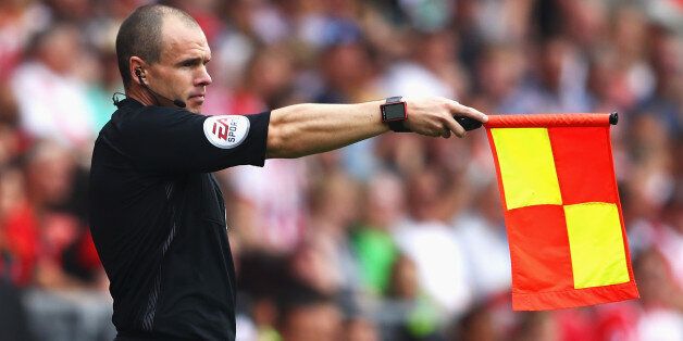 SOUTHAMPTON, ENGLAND - AUGUST 27: A assissant referee holds up the offside flag during the Premier League match between Southampton and Sunderland at St Mary's Stadium on August 27, 2016 in Southampton, England. (Photo by Michael Steele/Getty Images)
