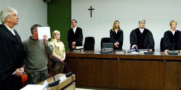 Defendant Olaf O (2nd L) of the far-right 'Oldschool Society' organisation stands next to his lawyer Hans Dieter Stoffer (L) before the start of his trial in a courtroom in Munich, southern Germany, April 27, 2016. / AFP / POOL / MICHAELA REHLE (Photo credit should read MICHAELA REHLE/AFP/Getty Images)