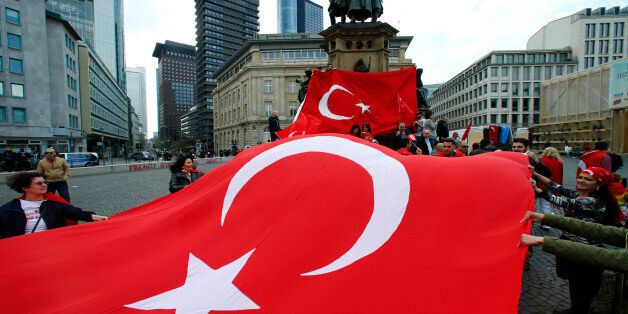 Pro-Turkish demonstrators hold a giant flag during a protest in Frankfurt, Germany April 10, 2016. A 'Peace March for Turkey and the EU', organized by