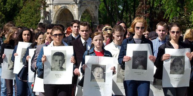 People hold portraits of children tortured and murdered by the Nazis inthe name of medicine during a funeral procession in Vienna's centralcemetery April 28, 2002. During 1940 and 1945 when Austria was part ofHitler's Third Reich, 789 mentally and physically handicapped childrenwere killed at Am Spiegelgrund hospital for leading worthless lives.About 600 urns with the children's remains have been buried under stoneplaques, six decades after their deaths. REUTERS/Heinz-Peter BaderHP/WS