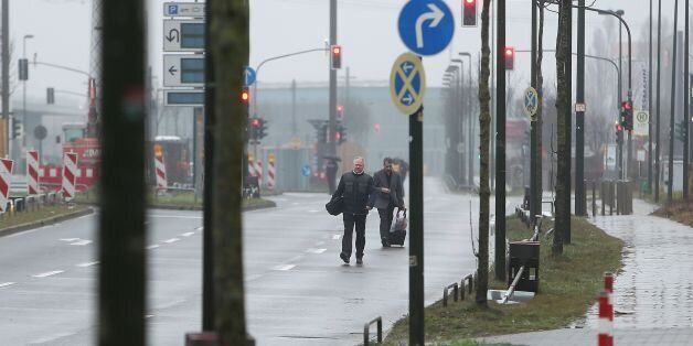 Evakuated hotel guests walk down a road near the site where a unexploded World War II bomb was found in Duesseldorf, western Germany, on March 9, 2017.Some 8,000 people were evacuated from homes, shops and offices in the western German city of Duesseldorf after an unexploded World War II bomb was uncovered, local authorities said. / AFP PHOTO / dpa / David Young / Germany OUT (Photo credit should read DAVID YOUNG/AFP/Getty Images)
